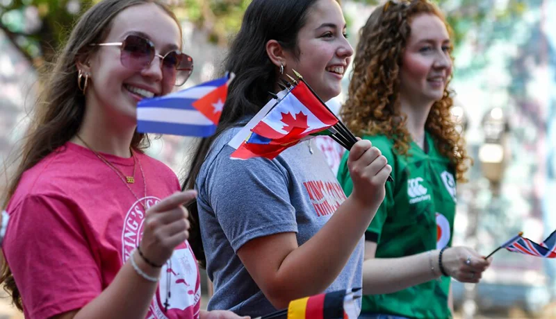 students holding small flags at a diversity event