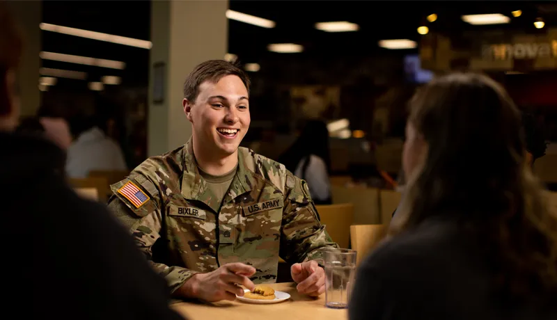 ROTC cadet sits at a table