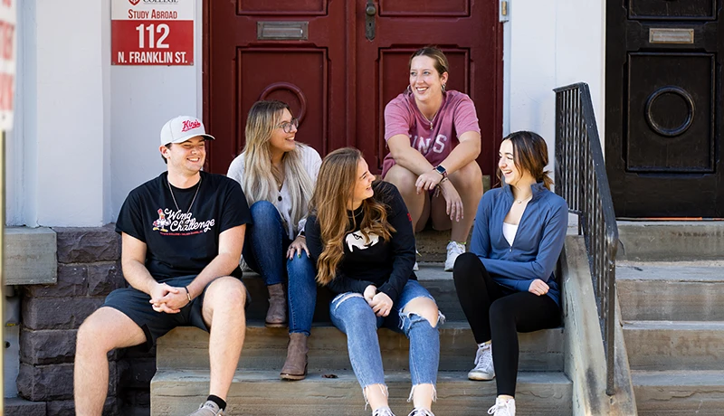 Students posing in front of the Study Abroad office