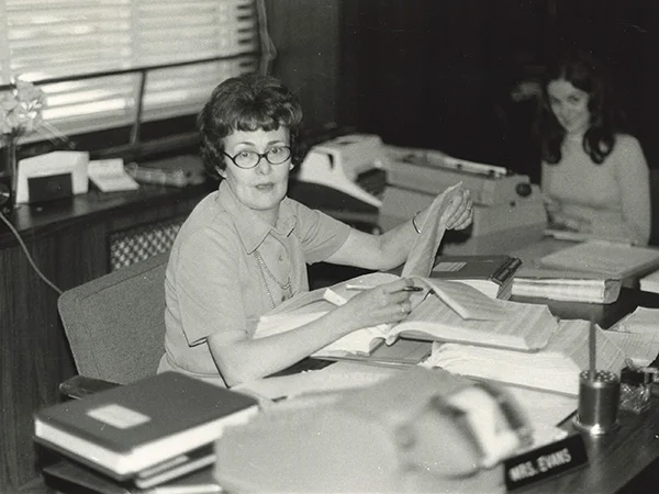 archival photo of secretary behind desk in the 1960s