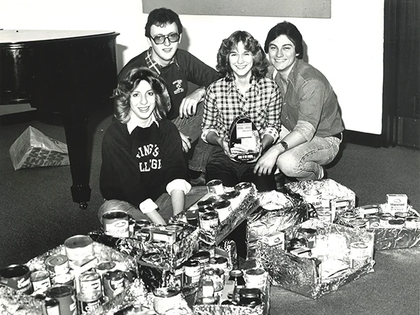 archival photo of students collecting canned goods in the 1980s