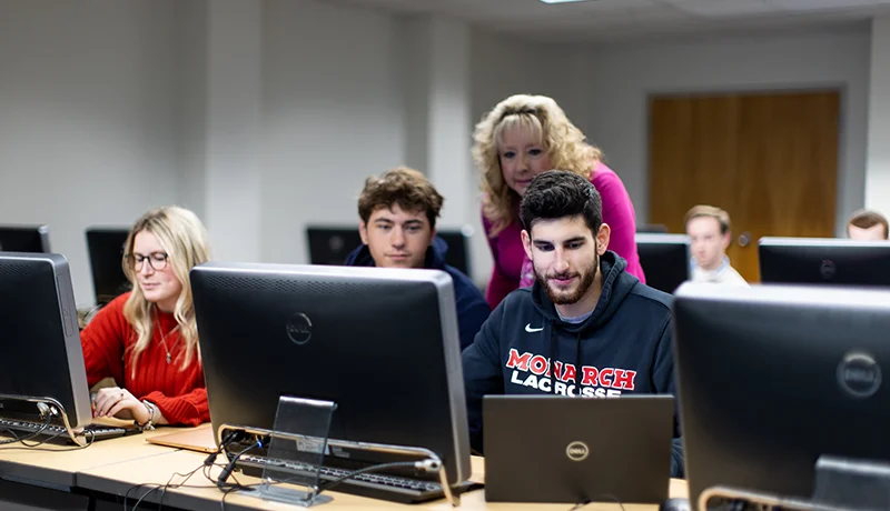 students in a computer lab with a professor