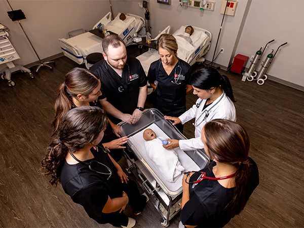 two nursing students talking in a pediatrics hospital setting