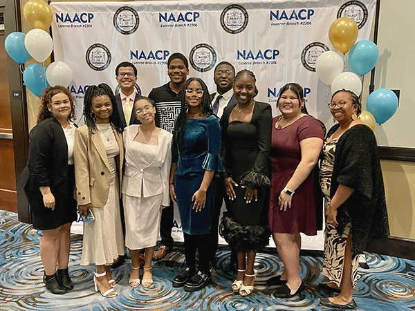 multicultural students posing at a NAACP event