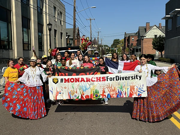 students carrying a banner at the diversity parade