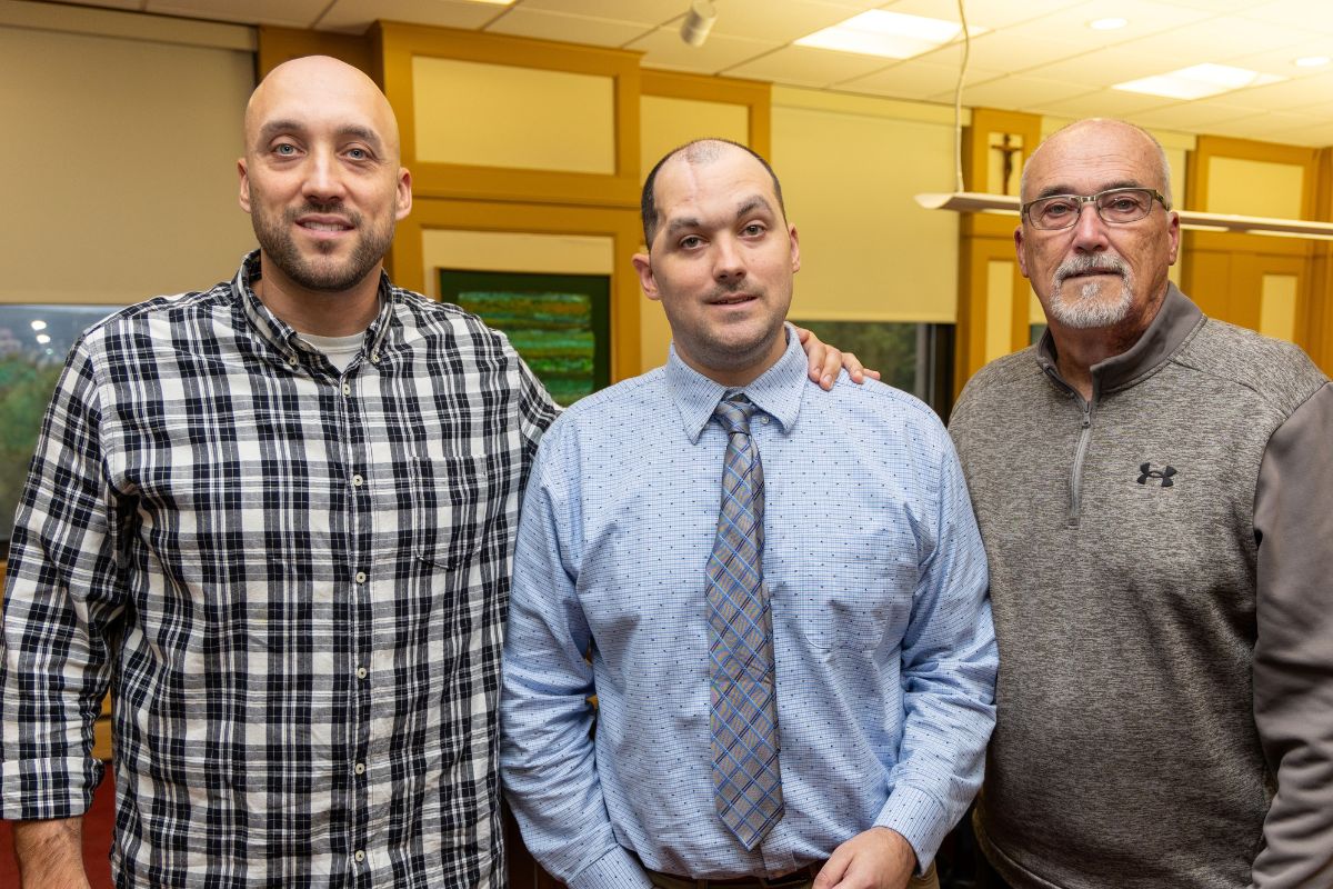 Kyle Gilmartin with his brother Ian, left, and his father William, right