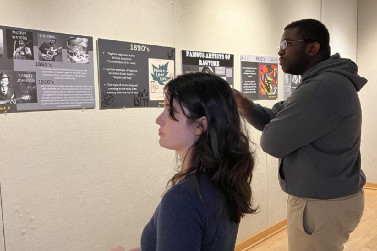 Students looking at the Balck History Month art gallery display. 