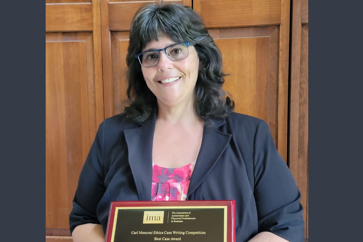 Dr. Shawver holding award