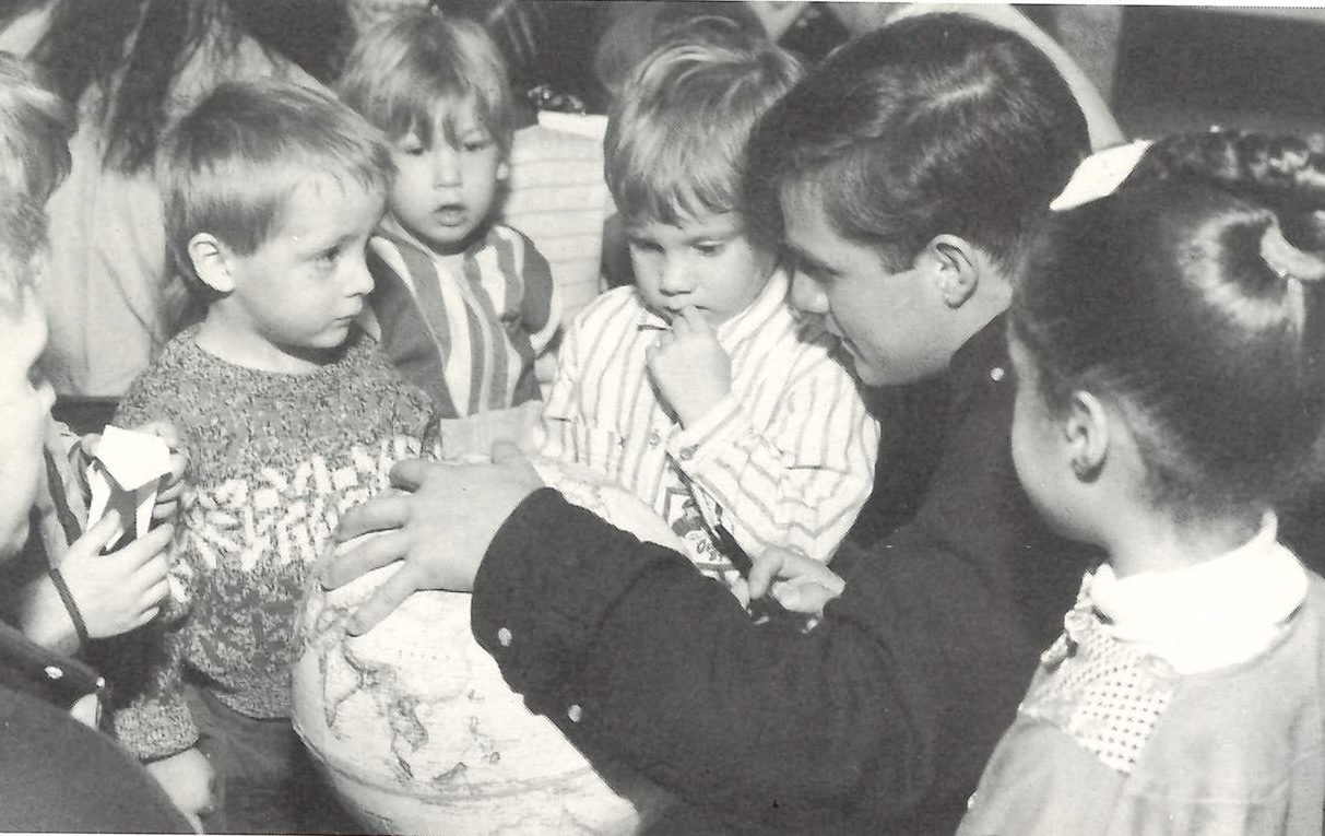 In 1993, José Donoso, a student from Ecuador and in the English as a Foreign Language program, shows a group of children where he is from during a class visit at a local day care center.