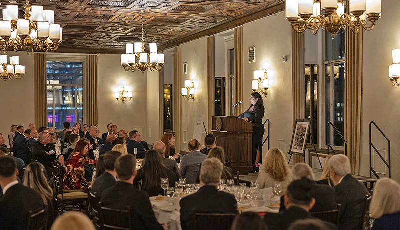 Alum attending a formal dinner with a speaker